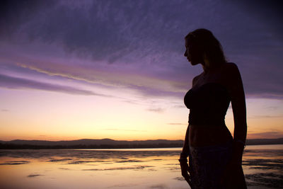 Woman looking away at sunset