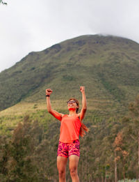 Full length of woman standing on mountain