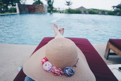 Woman sitting on chair at sea shore