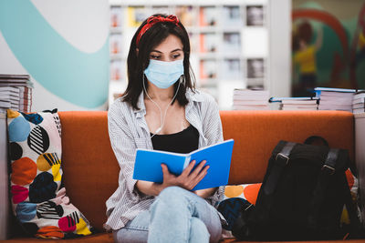 Young woman reading book