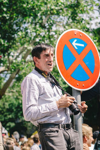 Man standing on road sign