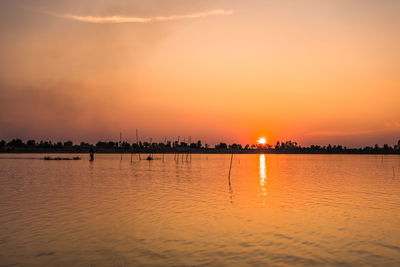 Scenic view of sea against orange sky