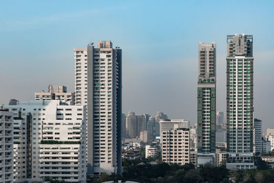 Buildings in city against clear sky