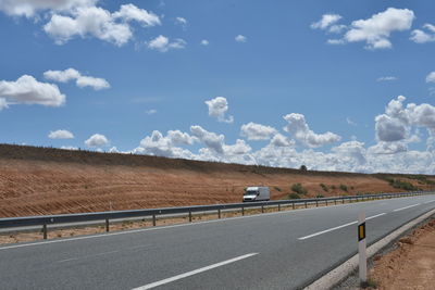 Road by highway against sky