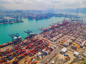 High angle view of commercial dock by sea against sky