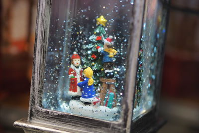 Close-up of christmas decoration in glass window