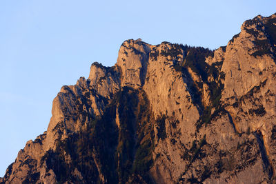 Low angle view of rock formations against clear sky