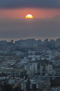 Close-up of cityscape against sky during sunset