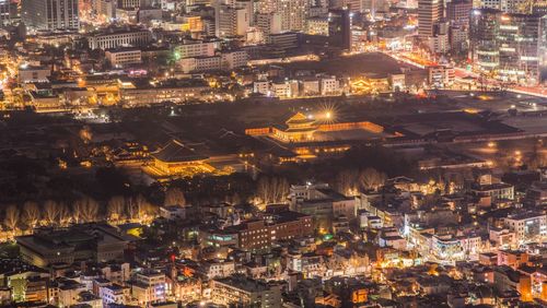 High angle view of city lit up at night