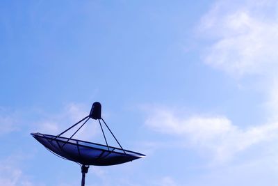 Low angle view of windmill against blue sky