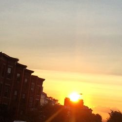 Low angle view of buildings against sky at sunset