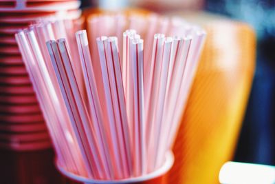 Close-up of drinking straws in container