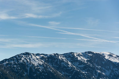 Scenic view of snowcapped mountains against blue sky