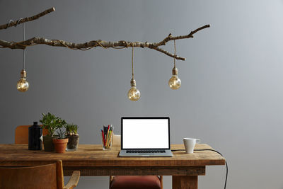 Illuminated electric lamp hanging on table