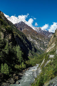 Scenic view of mountains against blue sky