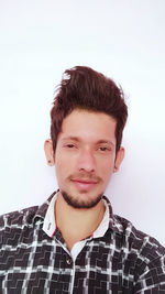 Portrait of young man against white background