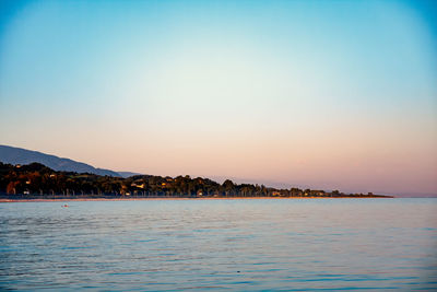 Scenic view of sea against clear sky at sunset