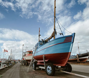 Old sailboat on a trailer in the harbor