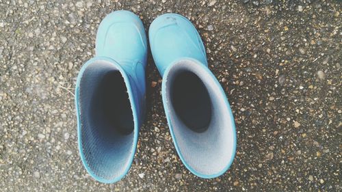 Directly above shot of rubber boots on street