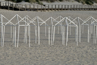 Metallic structure on beach by river against building