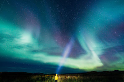 Young woman looking at aurora