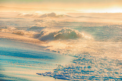 Aerial view of sea against sky during sunset