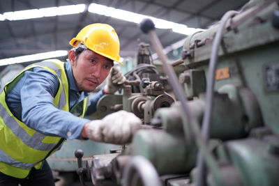 Rear view of man working in factory