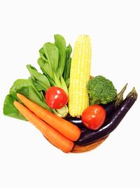 Fresh vegetables against white background