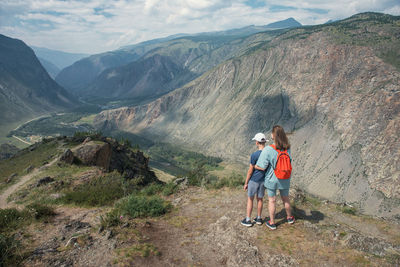 Rear view of people walking on mountain