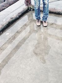 Low section of man standing on cobblestone