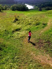 High angel view of woman walking on field