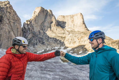 Two climber fist bump after a successful climb