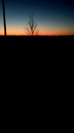 Silhouette landscape against clear sky at sunset