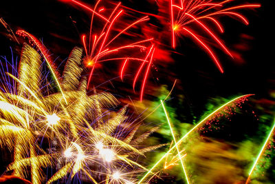 Low angle view of firework display at night