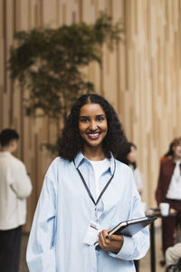 Portrait of young female entrepreneur at business conference at convention center