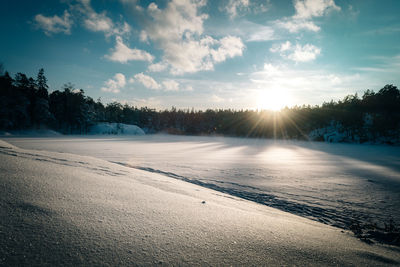 Scenic view of frozen lake against sky during winter