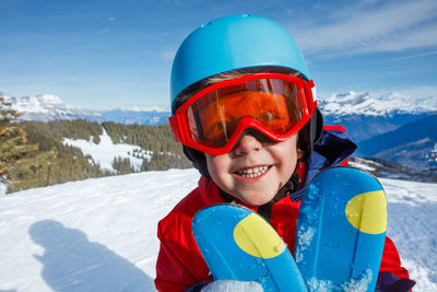 Portrait of young man skiing on snow