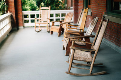 Empty chairs and tables at sidewalk cafe