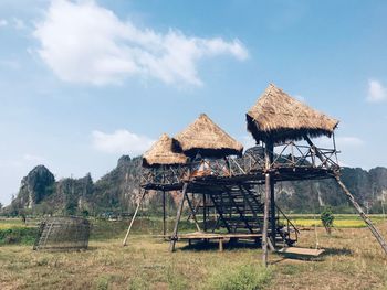 Traditional windmill on field against sky