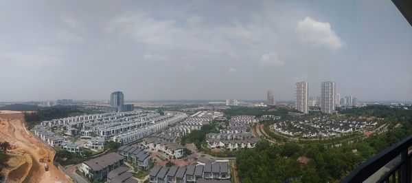 High angle view of modern buildings in city against sky