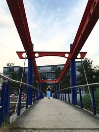 Bridge against cloudy sky