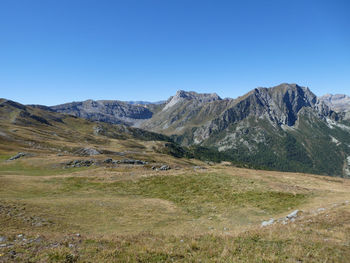 Scenic view of mountains against clear blue sky