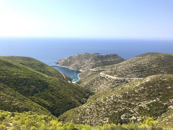 High angle view of sea and mountains against sky