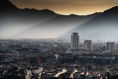 Aerial view of cityscape against sky during sunset