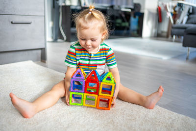 Portrait of boy sitting on floor