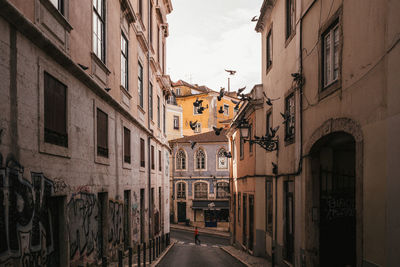 Narrow street amidst buildings in town