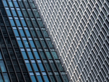 Close-up of modern glass building in city