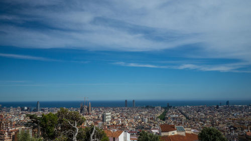 Aerial view of city against cloudy sky
