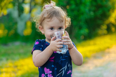 Portrait of cute girl drinking water