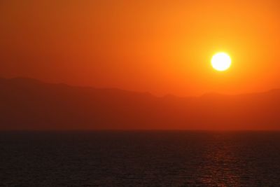 Scenic view of sea against romantic sky at sunset